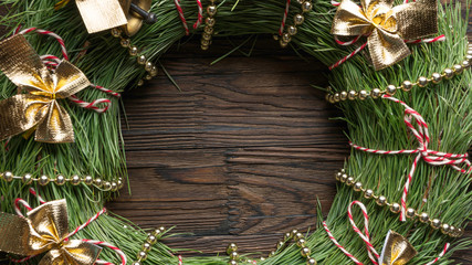 Christmas background. Christmas wreath with New Year decorations on a wooden background. Copy space for text