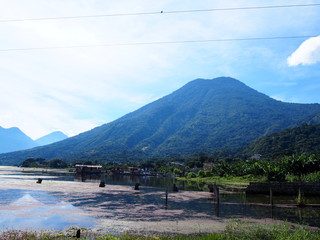 Large and majestic mountains and lakes with little water, San Pedro La Laguna, Guatemala