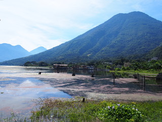 Large and majestic mountains and lakes with little water, San Pedro La Laguna, Guatemala