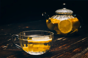 Cup of tea with lemon on a wooden table