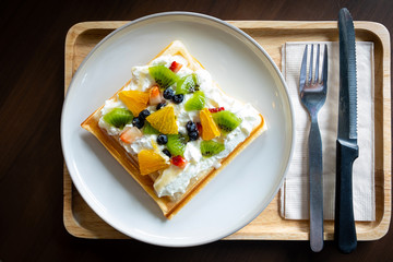 Waffle Fruity Kiwi Strawberry Blueberry Dessert. Fruity dessert food and drink category. Colorful Waffle Fruity. Close up shot. Top view Wide angle.