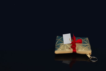 Small women bag to carry everyday personal items tied with a red bow, make up bag with cosmetics, gift, isolated on black background.