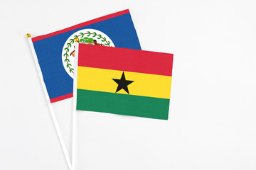 Obraz premium Ghana and Belize stick flags on white background. High quality fabric, miniature national flag. Peaceful global concept.White floor for copy space.
