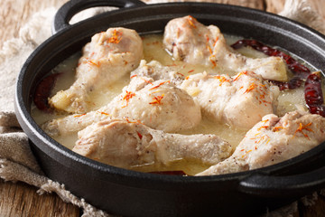 Bengali chicken rezala recipe (white chicken curry) close-up in a pan. horizontal