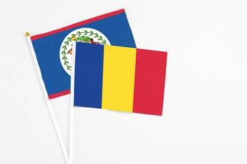 Romania and Belize stick flags on white background. High quality fabric, miniature national flag....