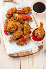 Chicken nuggets with sauce and pepper on a white board. Copy space.