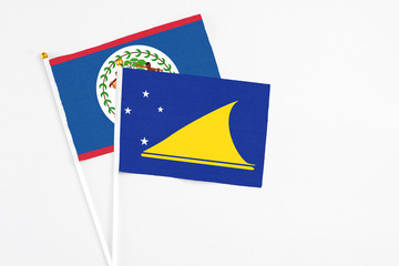 Tokelau and Belize stick flags on white background. High quality fabric, miniature national flag....