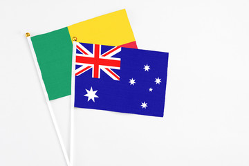 Australia and Benin stick flags on white background. High quality fabric, miniature national flag....