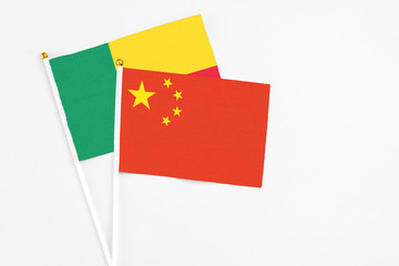 China and Benin stick flags on white background. High quality fabric, miniature national flag....