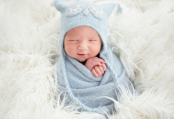 Cute newborn in knitted suit