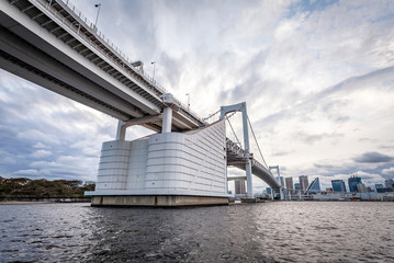 TOKYO, JAPAN - OCTOBER 6, 2019: The majestic Rainbow Bridge crossing northern Tokyo Bay between...
