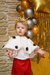 Little boy dressed as king with crown