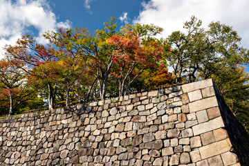 Defensive stone wall of Osaka-jo castle in autumn
