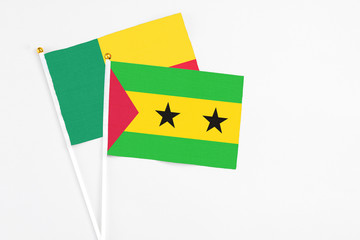 Sao Tome And Principe and Benin stick flags on white background. High quality fabric, miniature national flag. Peaceful global concept.White floor for copy space.