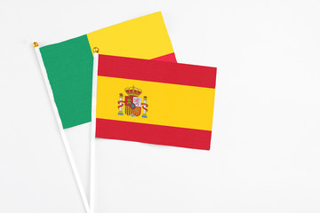 Spain and Benin stick flags on white background. High quality fabric, miniature national flag....