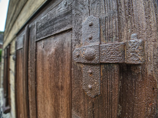 Outdoor view of part of ancient closed wooden shutters.