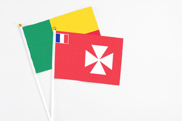 Wallis And Futuna and Benin stick flags on white background. High quality fabric, miniature...