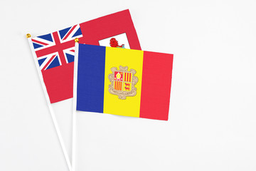 Andorra and Bermuda stick flags on white background. High quality fabric, miniature national flag. Peaceful global concept.White floor for copy space.