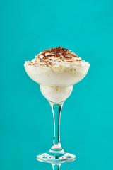 ice cream in glass with chocolate powder on Tiffani color background