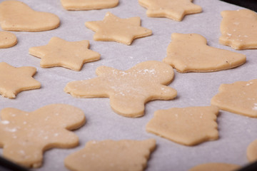 a pan full of beautiful Christmas cookies ready to bake in the oven