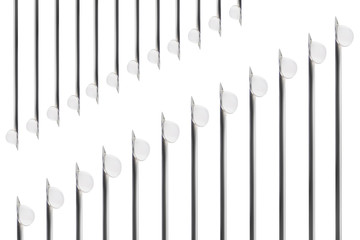 Needles of syringes and vaccine droplets on white background, closeup, isolated