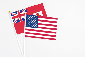United States and Bermuda stick flags on white background. High quality fabric, miniature national flag. Peaceful global concept.White floor for copy space.