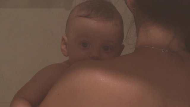 Mother bathing baby in shower mom holding infant