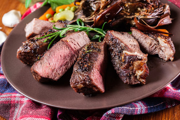 Slices of beef steak served with baked artichoke
