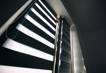 Sunlight enters the room through the blinds