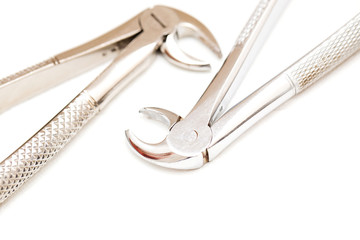 Dental forceps for removing teeth on a white isolated background.