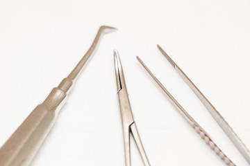 Set of metal tools in dentistry on a white isolated background.