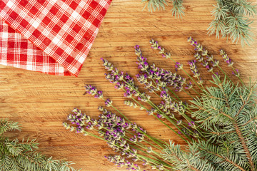 Lavender and checked red and white cloth towel on wooden table, top view flatlay, 