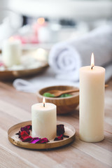 Burning candles on table in spa salon