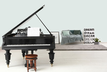 Stylish grand piano in light room