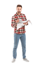 Handsome man with newspaper on white background