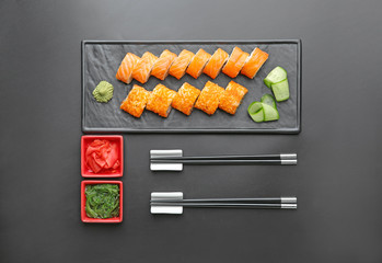 Set of tasty sushi rolls on dark background