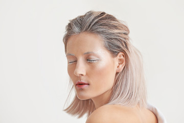 Naklejka premium Beautiful woman with creative makeup on white background