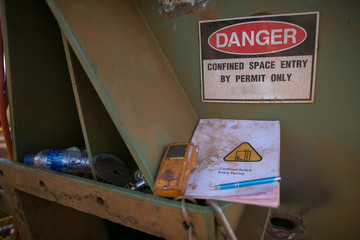 Danger confined space sign with gas detector and entry permit book at the  confined space entry...