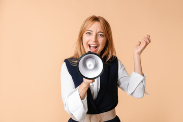 Mature woman with megaphone on color background