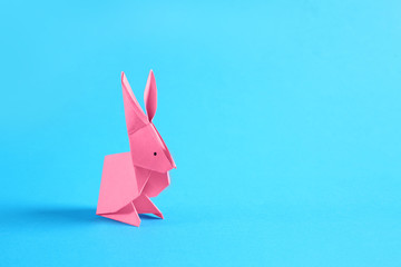 Origami rabbit on color background - obrazy, fototapety, plakaty