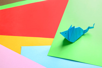 Origami rat on color background
