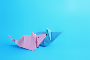 Origami rats on color background