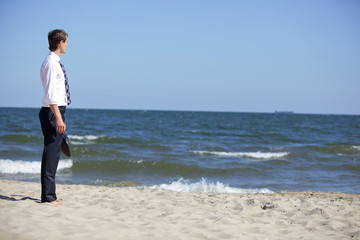 Caucasian business man dealing with emotional stress at the sea