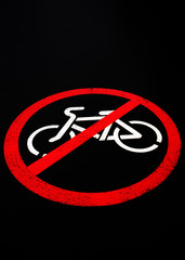 sign prohibiting ride a bicycle isolated on a black background