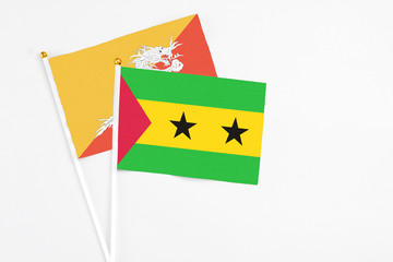 Sao Tome And Principe and Bhutan stick flags on white background. High quality fabric, miniature national flag. Peaceful global concept.White floor for copy space.