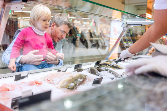Family buying fish in the supermarket