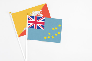Tuvalu and Bhutan stick flags on white background. High quality fabric, miniature national flag....