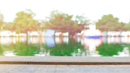 Empty wood table top on blur light bokeh of river, can be used for display or montage your products