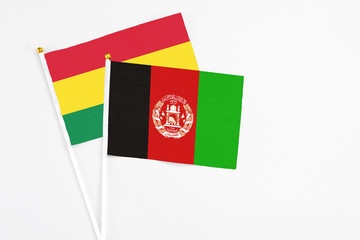 Afghanistan and Bolivia stick flags on white background. High quality fabric, miniature national...