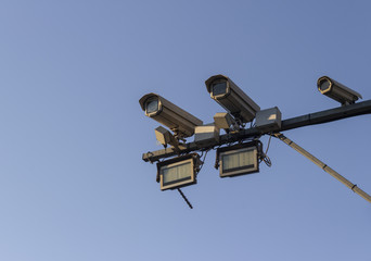 Security survaillance cameras cctv camera on post with traffic radar sky blue  background